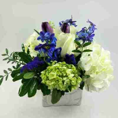 violet blue and white flower bouquet in ceramic pot